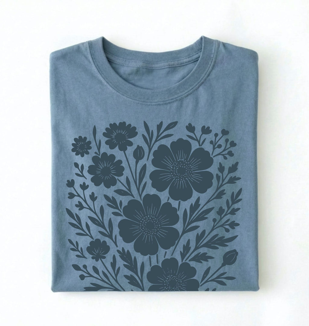 Folded blue t-shirt with floral pattern on a white background