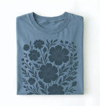 Folded blue t-shirt with floral pattern on a white background