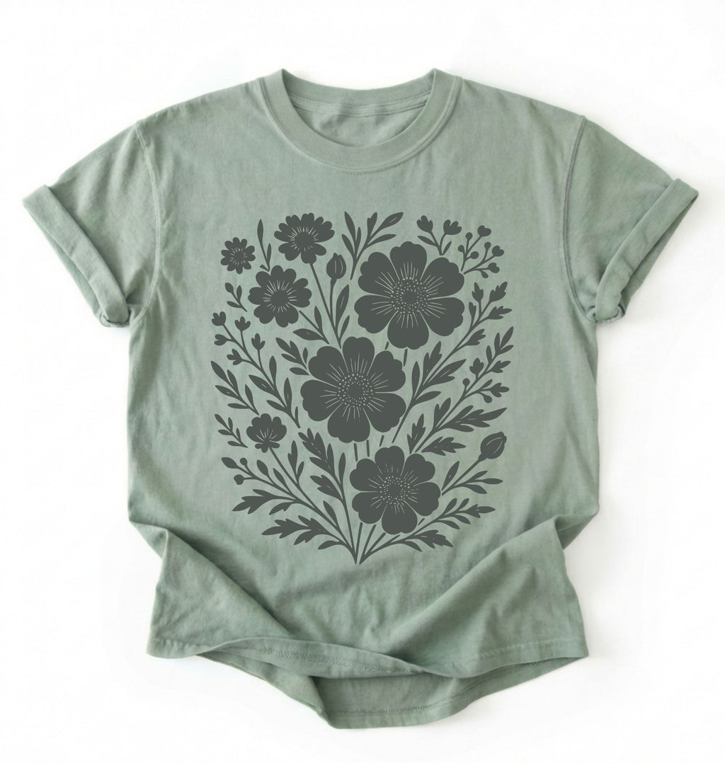 Green t-shirt with black floral design on a white background
