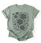 Green t-shirt with black floral design on a white background