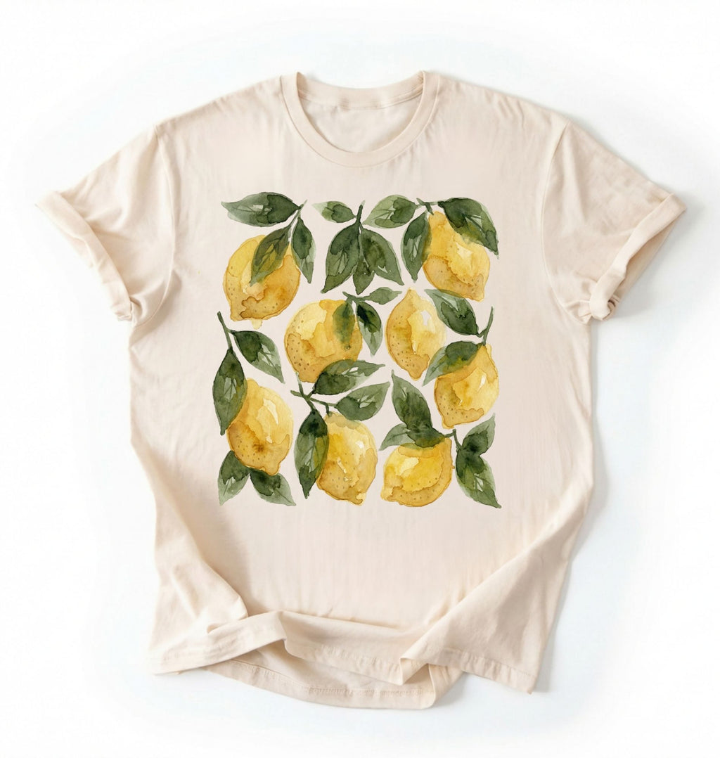 Flat lay Natural t-shirt with watercolor lemon and green leaf pattern, cottagecore style gardener gift tee on a white background