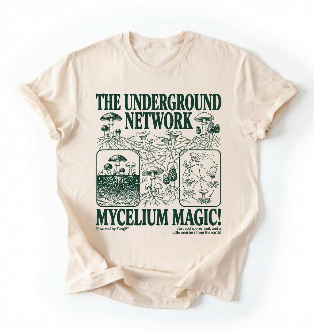 Flat lay of a white t-shirt featuring Mycelium network mushroom and root network illustrations with text reading “The Underground Network Mycelium Magic” with forest fungi design perfect gift for mushroom lovers nature fans and cottagecore style on a white background 