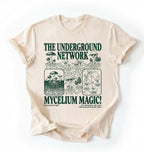 Flat lay of a white t-shirt featuring Mycelium network mushroom and root network illustrations with text reading “The Underground Network Mycelium Magic” with forest fungi design perfect gift for mushroom lovers nature fans and cottagecore style on a white background 