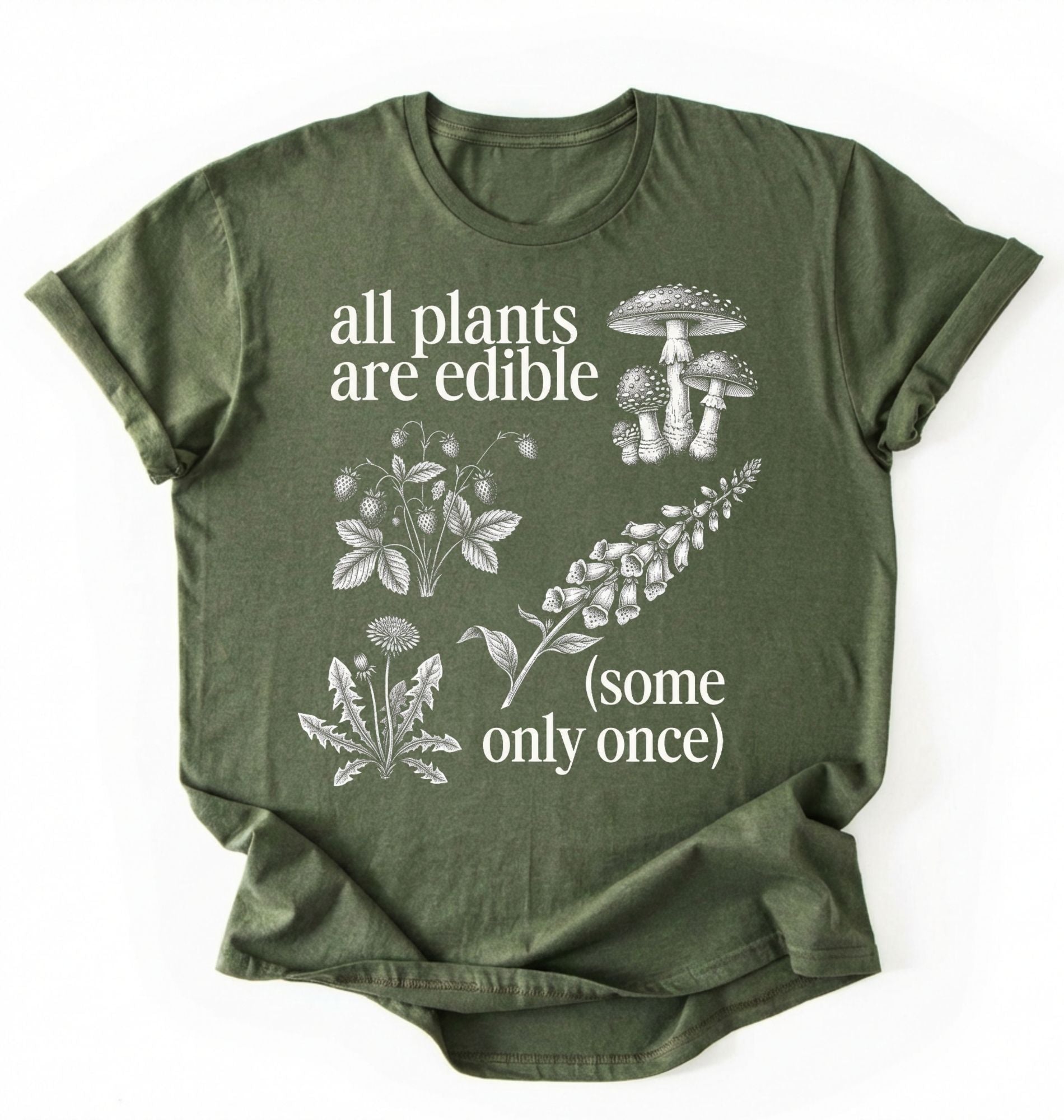 Flat lay of a Moss_MilitaryGreen shirt featuring botanical illustrations and text reading “All Plants Are Edible (Some Only Once).” with mushroom graphic for plant lover gardener gift cottagecore nature shirt on a white background 