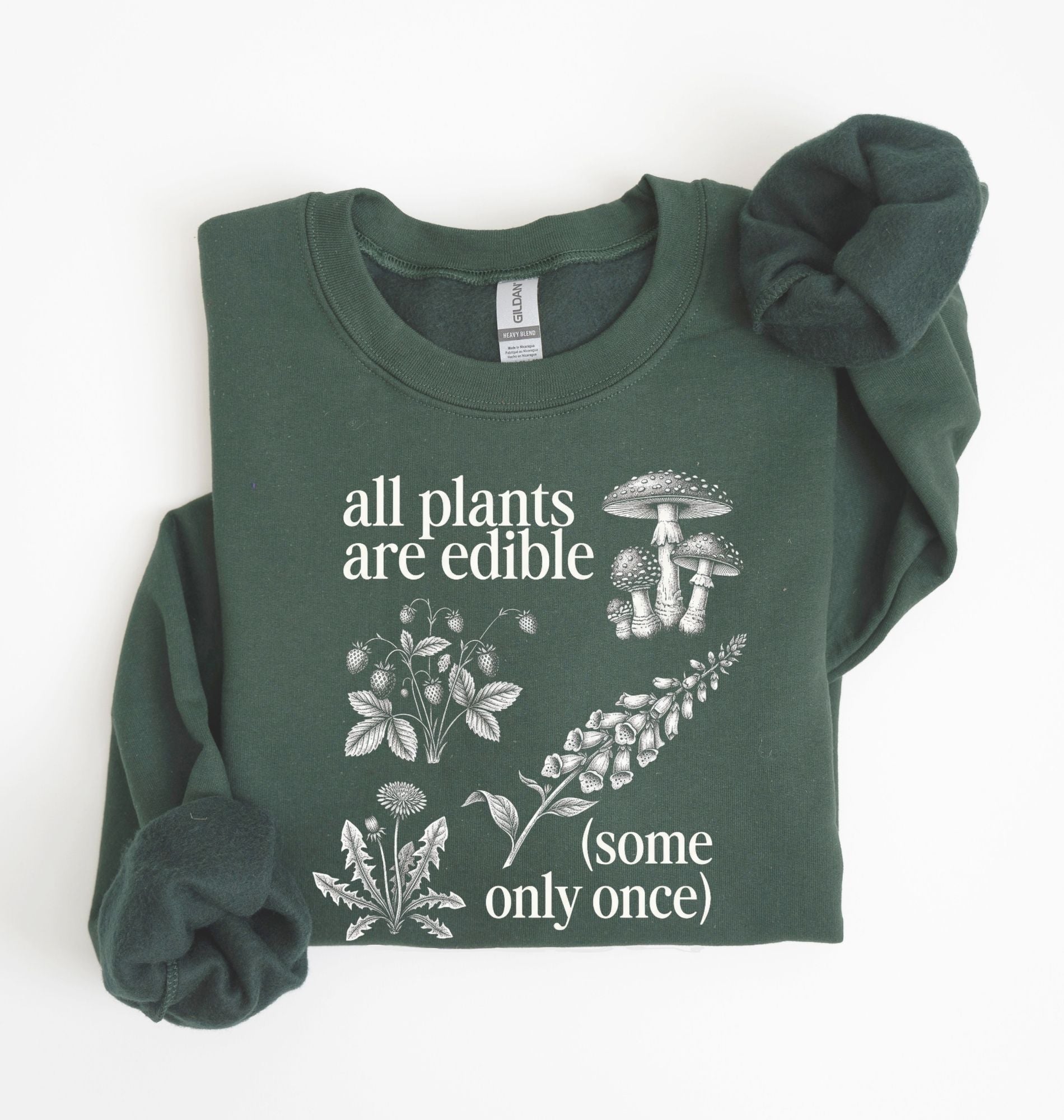 Flat lay of a forest green Funny plant lover sweatshirt some only once quote botanical illustration on a white background 
