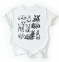 Flat lay of a white Baby farm animals t-shirt with illustrated lamb, calf, piglet, duckling, chick, donkey, goat, and bunny on a white background