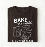 Flat lay of a Funny baking pun shirt with flour butter and eggs illustration on brown tee on a white background 