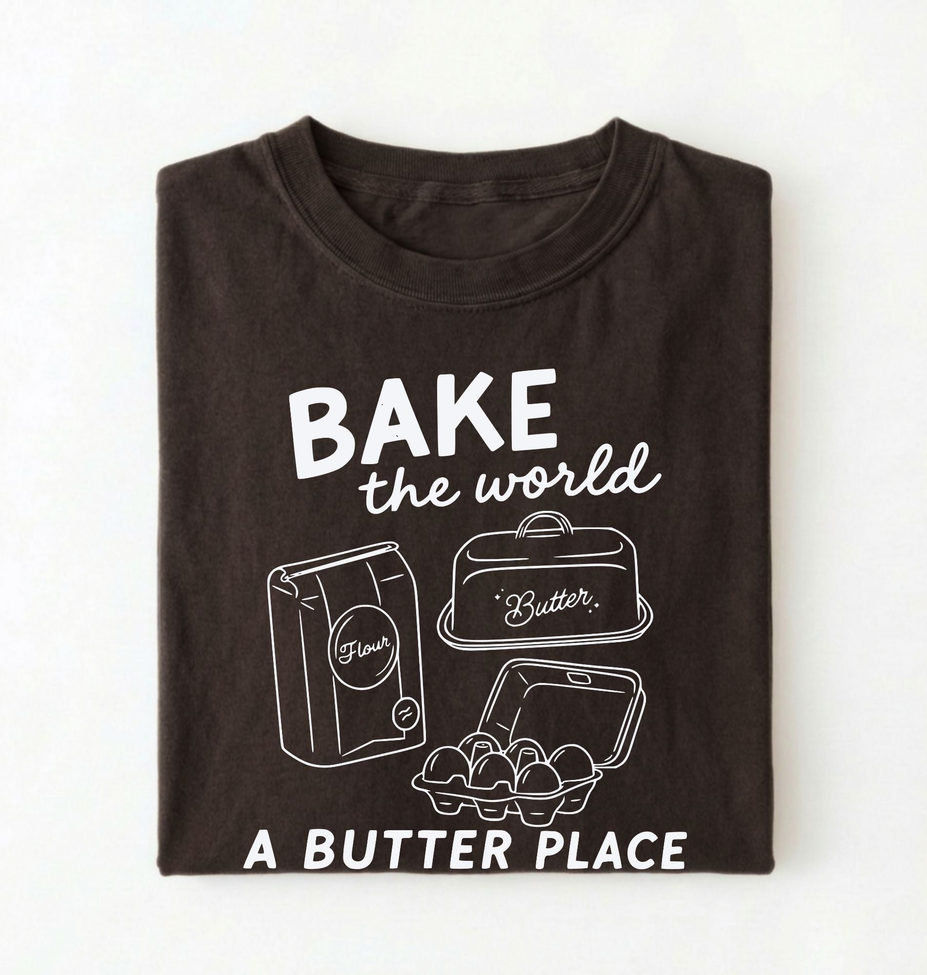 Flat lay of a Funny baking pun shirt with flour butter and eggs illustration on brown tee on a white background 