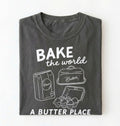 Flat lay of a Funny baking pun shirt with flour butter and eggs illustration on pepper tee on a white background 