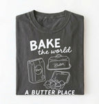 Flat lay of a Funny baking pun shirt with flour butter and eggs illustration on pepper tee on a white background 