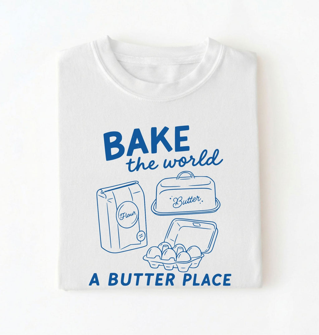 Flat lay of a Funny baking pun shirt with flour butter and eggs illustration on white tee on a white background 