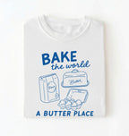 Flat lay of a Funny baking pun shirt with flour butter and eggs illustration on white tee on a white background 