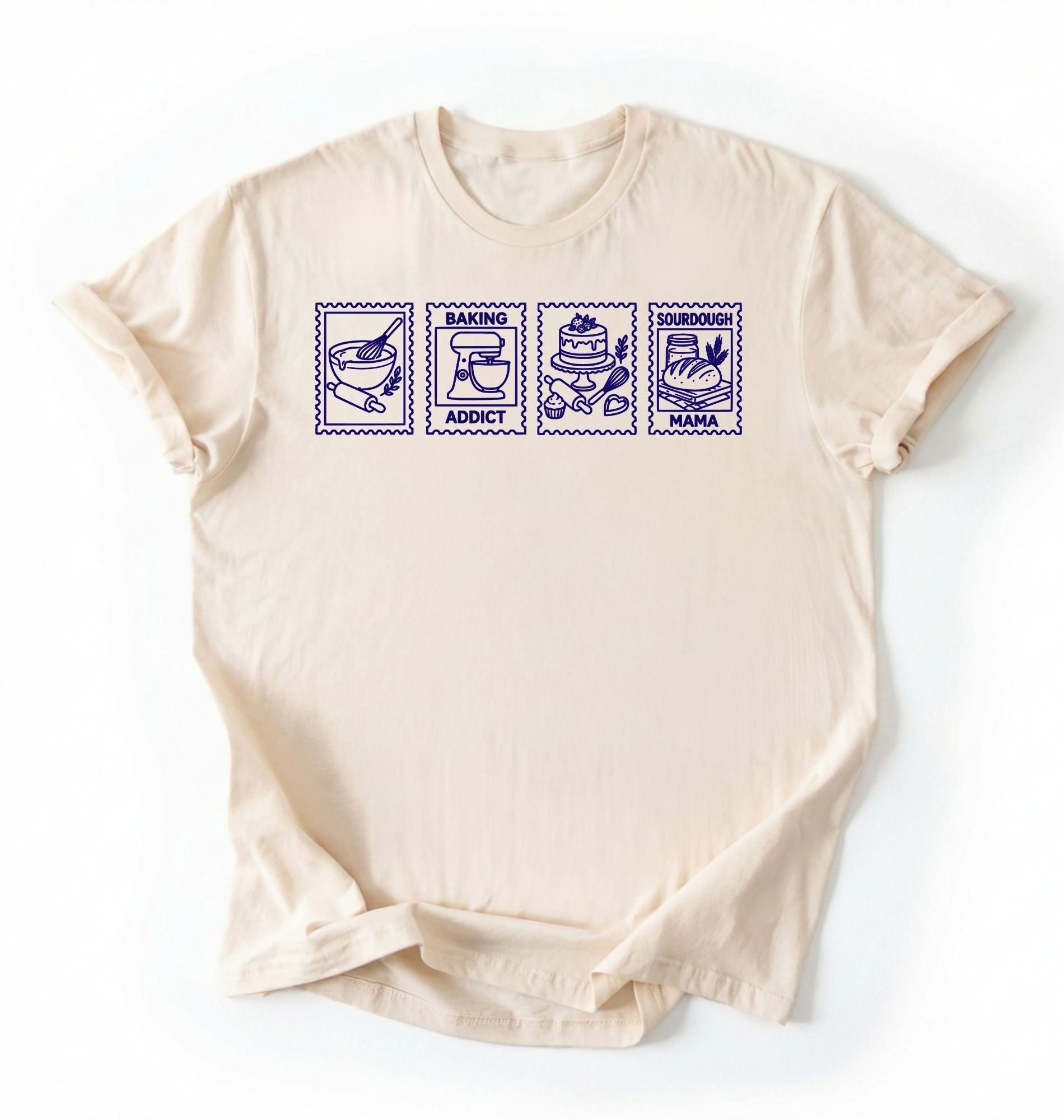 Flat lay of a cream Baking Addict Sourdough Mama graphic shirt with vintage baking stamp design for bread bakers on a white background 