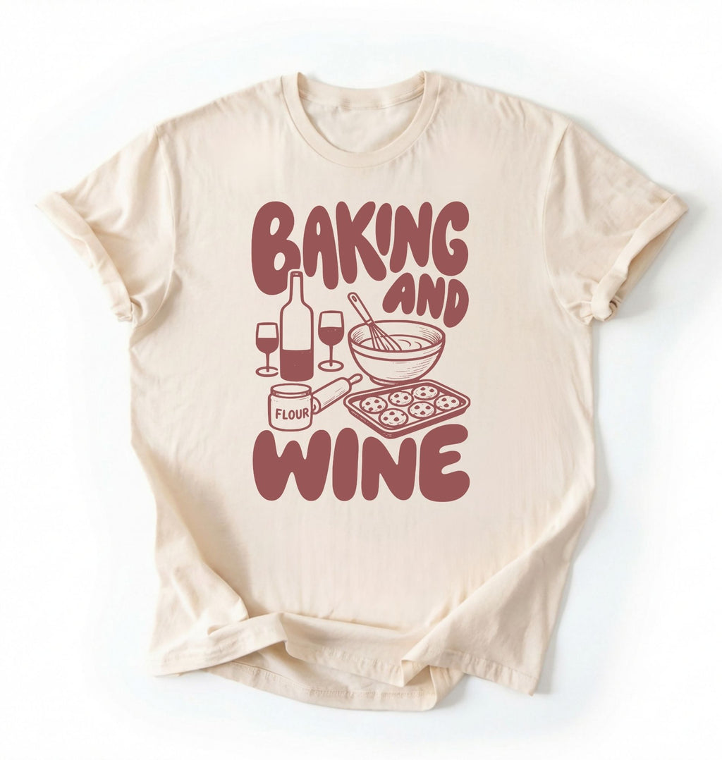 Flat lay of a cream Baking and Wine graphic shirt for home bakers featuring baking tools and wine themed design on a white background