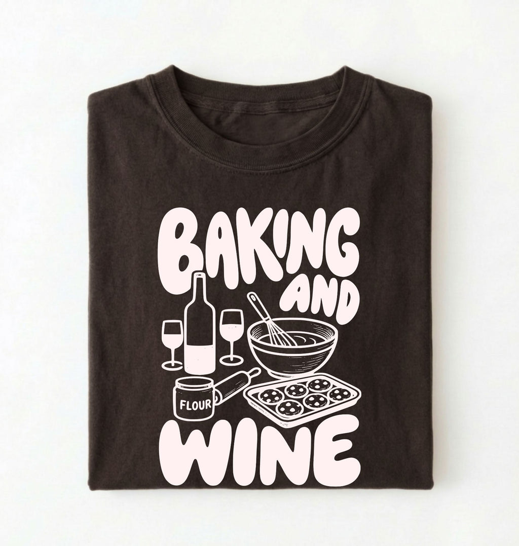 Flat lay of a brown Baking and Wine graphic shirt for home bakers featuring baking tools and wine themed design on a white background