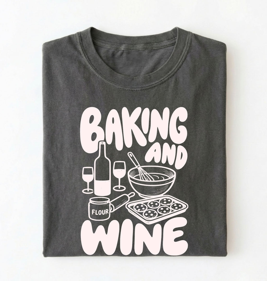 Flat lay of a gray Baking and Wine graphic shirt for home bakers featuring baking tools and wine themed design on a white background