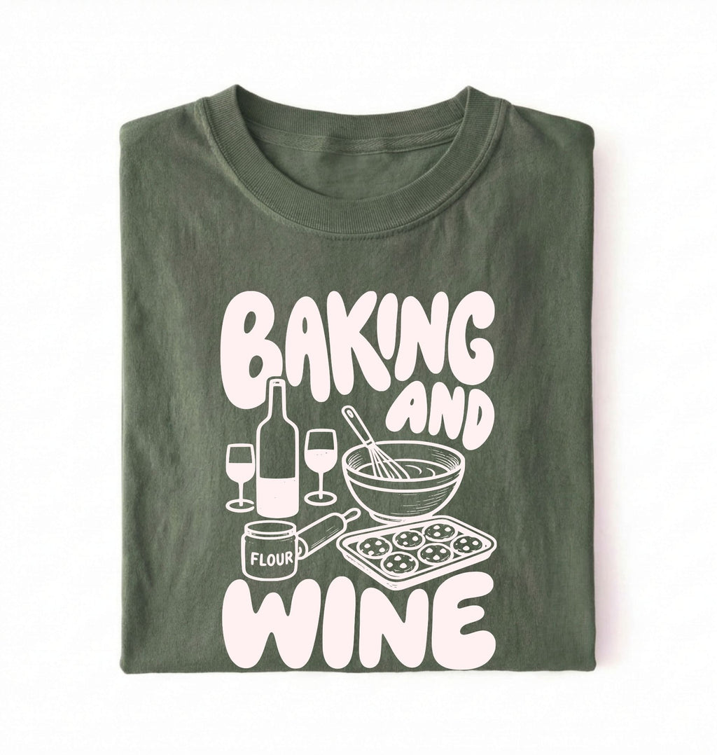 Flat lay of a green Baking and Wine graphic shirt for home bakers featuring baking tools and wine themed design on a white background
