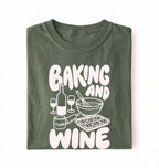 Flat lay of a green Baking and Wine graphic shirt for home bakers featuring baking tools and wine themed design on a white background