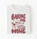 Flat lay of a white Baking and Wine graphic shirt for home bakers featuring baking tools and wine themed design on a white background