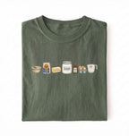 Flat lay of a green baking ingredients shirt with flour butter sugar eggs vanilla and measuring cup baker gift on a white background 