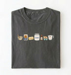 Flat lay of a charcoal baking ingredients shirt with flour butter sugar eggs vanilla and measuring cup baker gift on a white background 