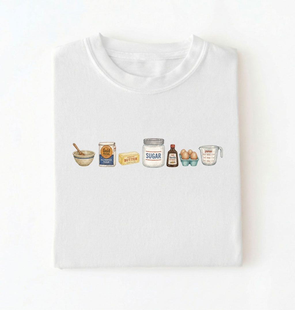 Flat lay of a white baking ingredients shirt with flour butter sugar eggs vanilla and measuring cup baker gift on a white background 