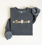 Flat lay of a dark heather baking ingredients sweatshirt with flour butter sugar eggs vanilla and baking essentials design on a white background