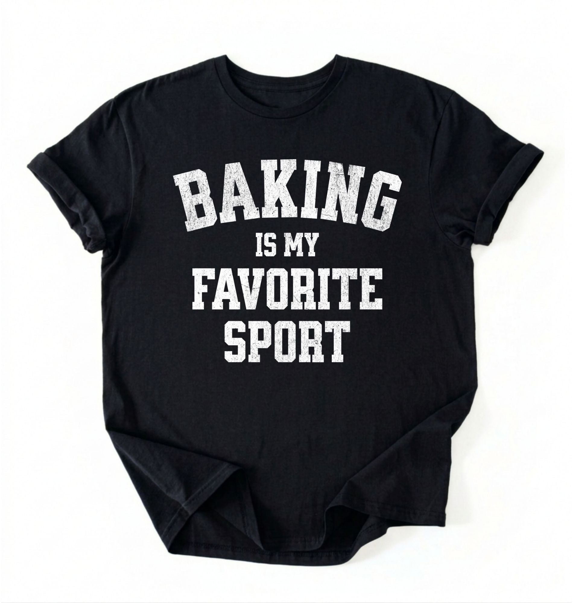 Flat lay of a black Baking Is My Favorite Sport graphic shirt on navy blue t-shirt for home bakers on a white background 