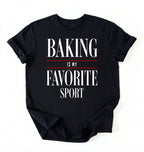 Flat lay of a black Baking Is My Favorite Sport graphic shirt for home bakers and baking enthusiasts on a white background 