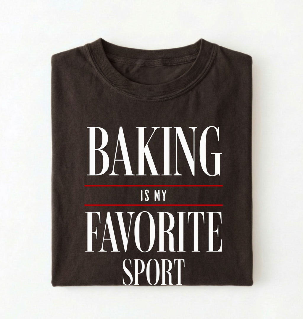 Flat lay of a brown Baking Is My Favorite Sport graphic shirt for home bakers and baking enthusiasts on a white background 