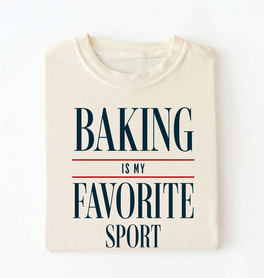 Flat lay of a ivory Baking Is My Favorite Sport graphic shirt for home bakers and baking enthusiasts on a white background 