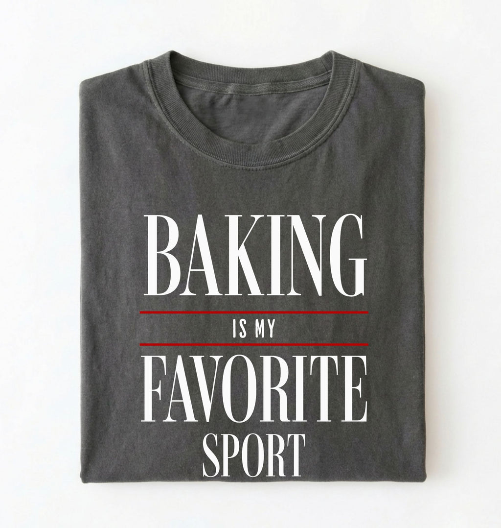 Flat lay of a gray Baking Is My Favorite Sport graphic shirt for home bakers and baking enthusiasts on a white background 