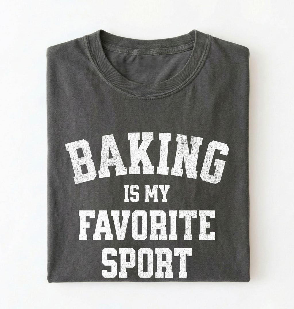 Flat lay of a pepper Baking Is My Favorite Sport graphic shirt on navy blue t-shirt for home bakers on a white background 