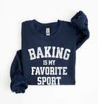 Flat lay of a navy Baking Is My Favorite Sport graphic sweatshirt on navy blue crewneck for home bakers on white background
