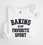 Flat lay of a white Baking Is My Favorite Sport graphic sweatshirt on navy blue crewneck for home bakers on white background