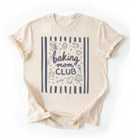 Flat lay of an ivory Baking Mom Club graphic shirt with baking tools and dessert icons for home bakers on a white background 