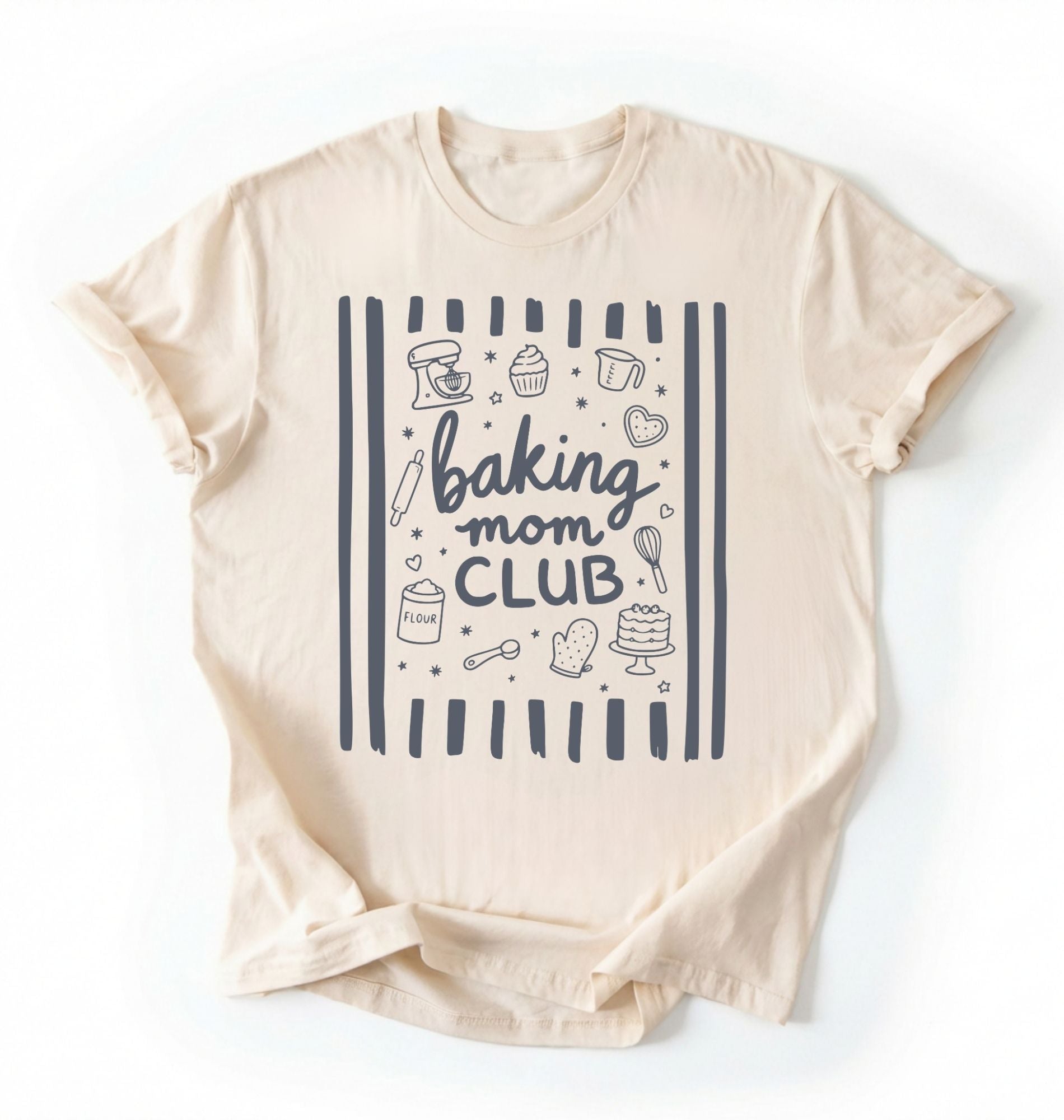 Flat lay of an ivory Baking Mom Club graphic shirt with baking tools and dessert icons for home bakers on a white background 