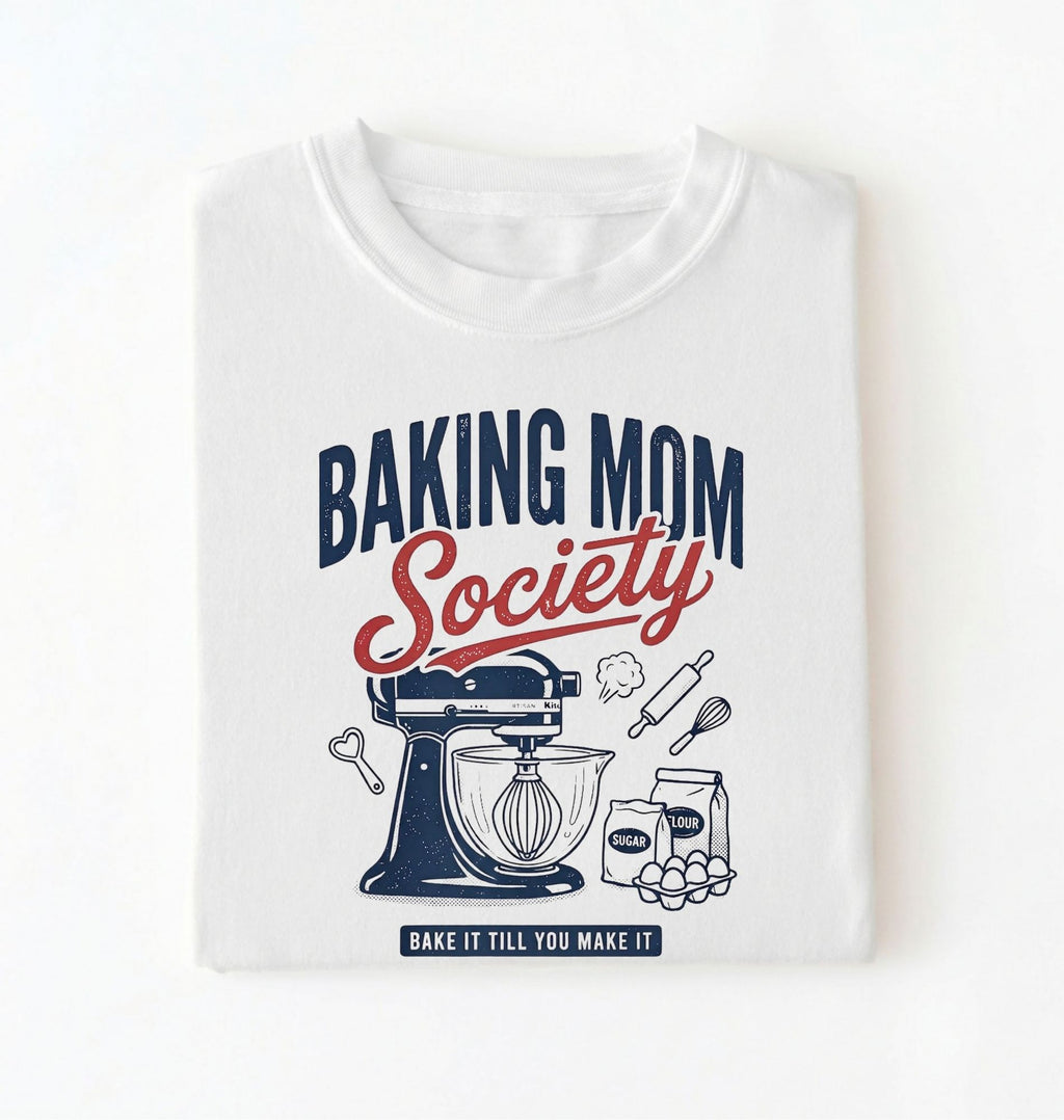 Flat lay of a white baking mom society shirt with stand mixer and baking ingredients baking mom gift on a white background 