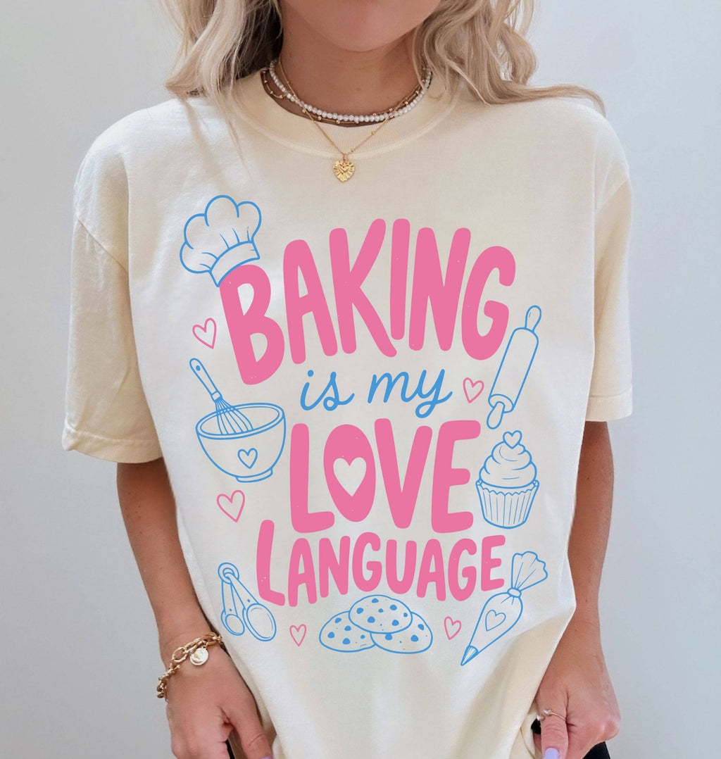 Person wearing a t-shirt with 'Baking is my love language' design on a plain background