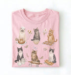 Pink t-shirt with cat illustrations on a white background