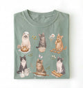 Green t-shirt with cat illustrations on a white background
