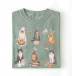 Green t-shirt with cat illustrations on a white background