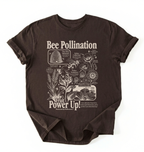 A dark brown short-sleeve t-shirt with a detailed white graphic print about bee pollination and its connection to fruit, laid flat against a white background.