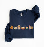 A navy blue long-sleeve sweatshirt with a holiday-themed graphic of baking ingredients (gingerbread, bowl, honey, pie, eggs, milk, Christmas tree) across the chest, displayed flat on a white background.