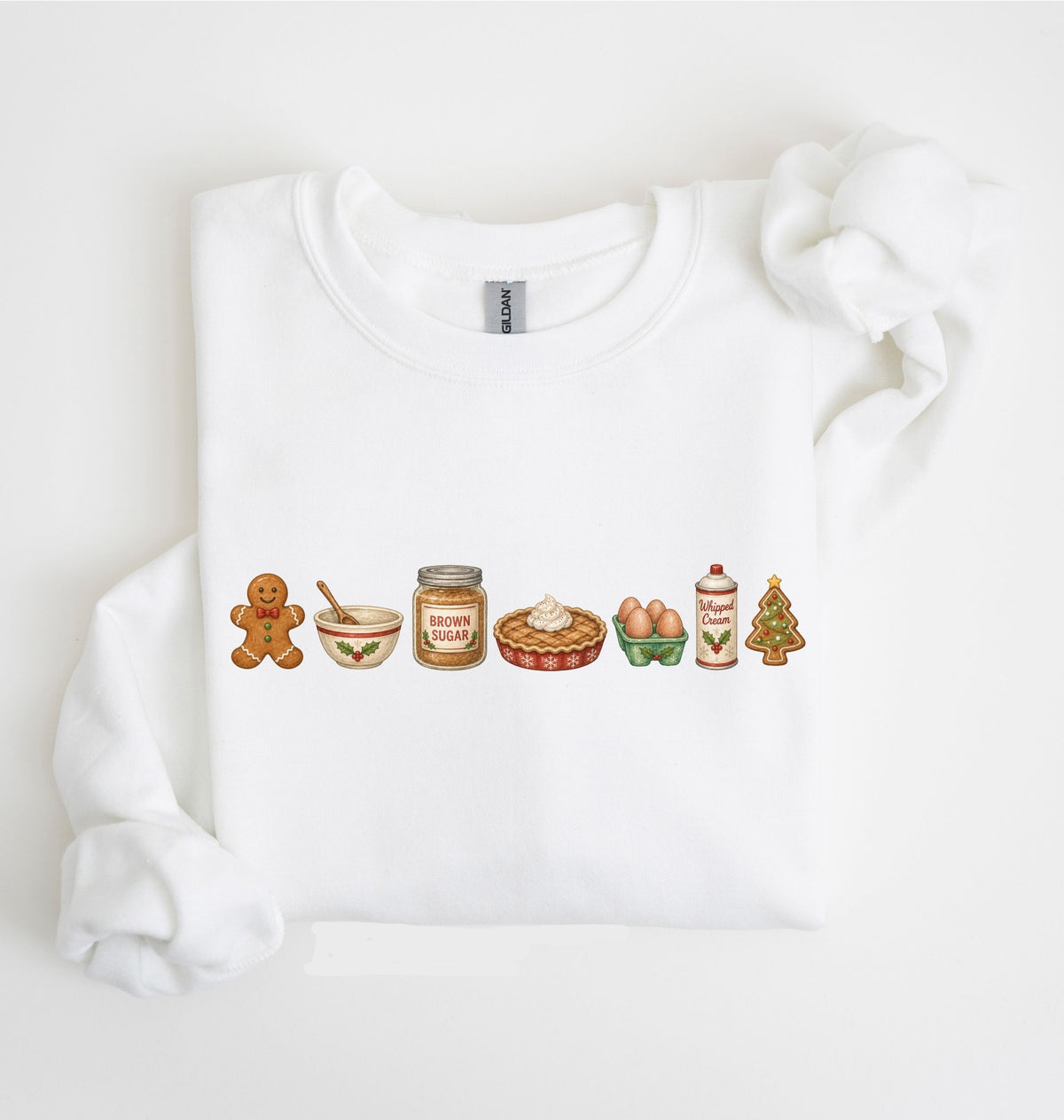A white crewneck sweatshirt featuring a horizontal row of Christmas-themed gingerbread illustrations across the chest, displayed on a clean white background.