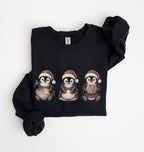 A black crewneck sweatshirt with 'BAKING weather' printed in white on the front, folded neatly on a white background.