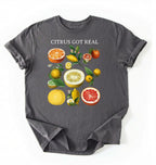 Flat lay white t shirt with the text White t-shirt with citrus fruit graphic and text 'Citrus Got Real' on a white background