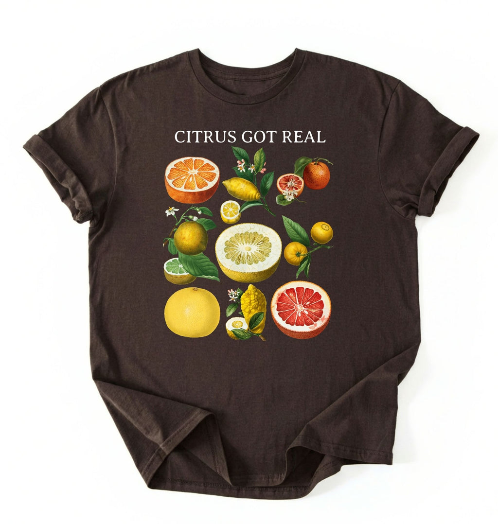 Flat lay dark_chocolate t shirt with the text White t-shirt with citrus fruit graphic and text 'Citrus Got Real' on a white background
