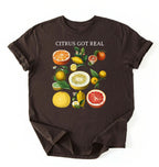 Flat lay dark_chocolate t shirt with the text White t-shirt with citrus fruit graphic and text 'Citrus Got Real' on a white background