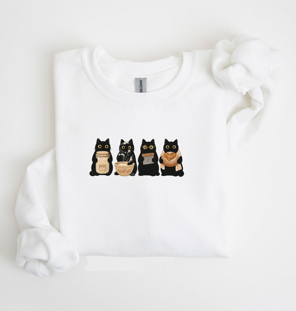 Flat lay of an white Cute black cat baker sweatshirt featuring baking cats with bread and mixing bowl crewneck on a white background 